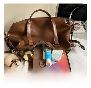 Large capacity interior of brown leather tote showing space for tablet and phone