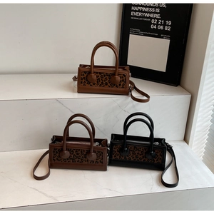 Three leopard print mini square bags in brown and black on marble display steps