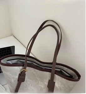 Top-down view of spacious tote bag showing striped lining, zipper pocket and marble texture