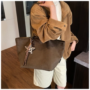 Detail of dark brown matte leather tote bag with FREE COLOR embossing and leopard star charm