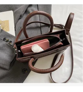 Interior view of brown leather bag showing spacious capacity for phone and wallet