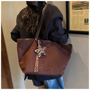 Dark brown suede tote bag with leopard star charm and Free Color embossed logo