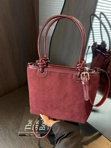 Wine red suede tote bag with knotted handle and elegant decorative leather buckle