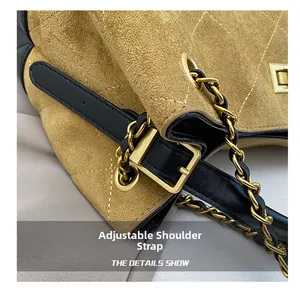 Detail of adjustable leather strap with vintage gold hardware on brown suede bag