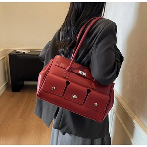 Side view of a vintage red leather tote bag with dual front pockets on a model