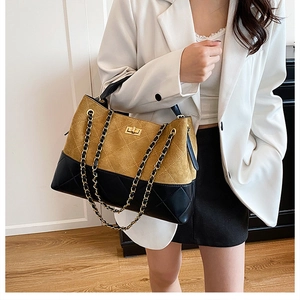 Quilted two-tone tote bag with gold chain strap and khaki suede finish shown on model