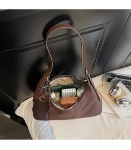 Detail showing the large interior capacity of this retro brown leather hobo bag