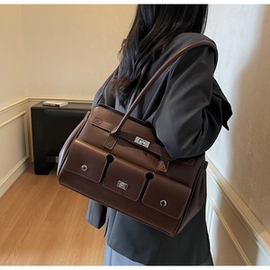 Brown leather shoulder bag with vintage silver metal buckles and multiple pockets