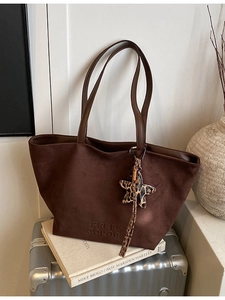Retro coffee suede tote bag with leopard star charm on vintage silver suitcase