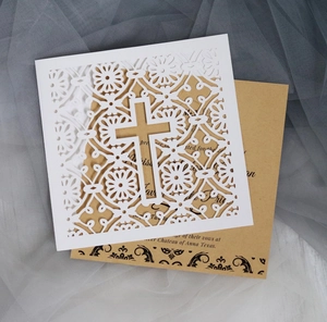 Detailed laser-cut white cross invitation with kraft paper insert on white mesh fabric
