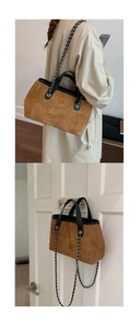 Detail of vintage brown suede tote bag featuring silver chain strap and leather handles