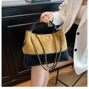 Close-up of ginger suede and black leather patchwork tote with golden turn-lock