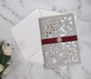 Silver glitter laser cut snowflake invitation card with red ribbon and crystal brooch