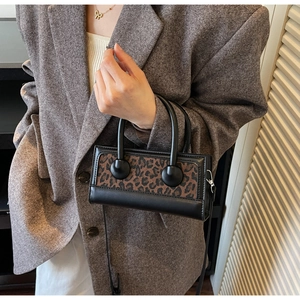 Fashionable leopard print handbag styled with a grey coat for a trendy autumn winter look