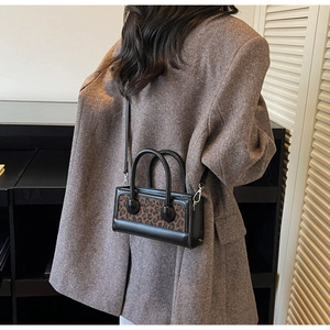 Leopard print crossbody mini bag styled on model with a brown blazer suit