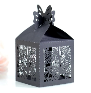 Detail of laser-cut butterfly and floral patterns on black hollow gift candy box