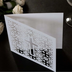 Elegant white laser-cut wedding invitation card with cross pattern and lace details