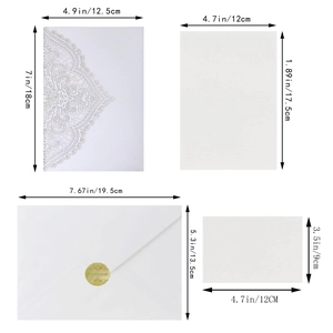 Elegant white laser-cut wedding invitation set with envelopes and gold seals