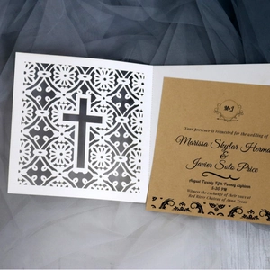 Elegant laser-cut floral wedding invitation with cross pattern and kraft paper insert