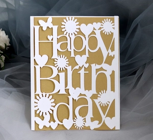 Close-up of laser-cut Happy Birthday card with intricate flower and butterfly hollow design