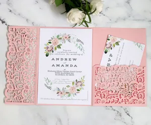 Macro detail of laser-cut hollow heart pattern on pink wedding invitation pocket