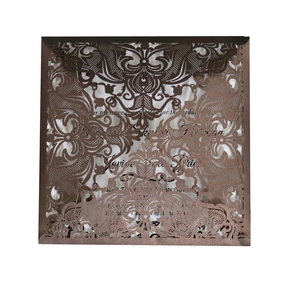 Detailed laser-cut wedding invitation cover with champagne glitter floral patterns