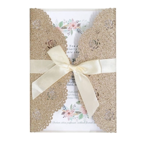 Elegant gold glitter laser-cut rose wedding invitation with ivory ribbon and floral insert
