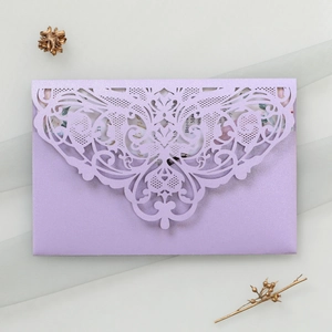 Close-up of lavender laser-cut wedding invitation envelope with pearl texture finish