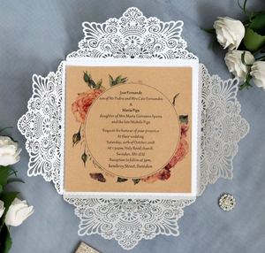Elegant laser-cut floral wedding invitation with kraft card and decorative white roses