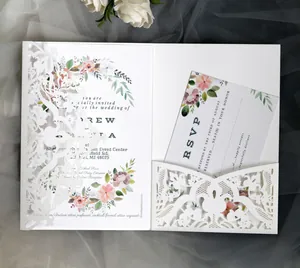 Macro view of laser-cut lace invitation sleeve with elegant floral wedding cards