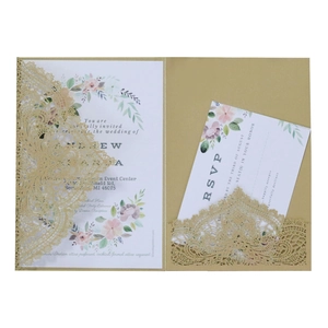 Golden laser-cut wedding invitation set with floral motif and lace patterns