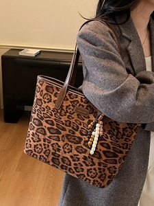 Fashion leopard print tote bag with brown handles and stylish bead charm accessory