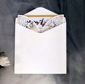 Elegant laser-cut floral wedding invitation card with white envelope and flower lining