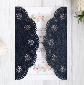 Detail of laser-cut navy glitter rose wedding invitation with elegant floral inner card