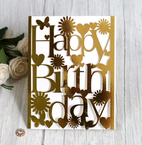 Macro detail of laser-cut Happy Birthday card with gold mirror finish and sunflower motifs