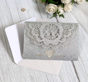 Elegant silver glitter laser-cut wedding invitation card with white rose and envelope