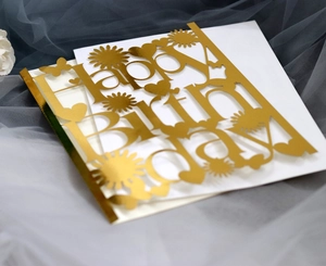 Golden mirror Happy Birthday cake topper with artistic hollow design on white background