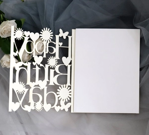 Macro view of cream laser-cut Happy Birthday card with elegant butterfly and sun patterns