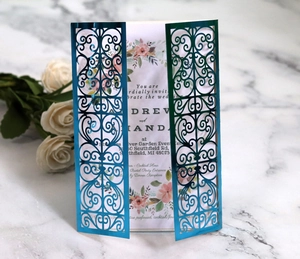 Macro detail of laser-cut wedding invitation shell with elegant floral inner page