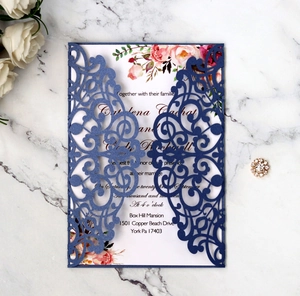 Detailed view of laser-cut navy blue wedding invitation with floral insert card