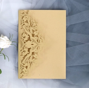 Detail of laser-cut gold lace invitation card with intricate hollow pattern and pearly texture