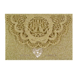 Golden glitter wedding invitation card with laser-cut hollow pattern and white heart detail