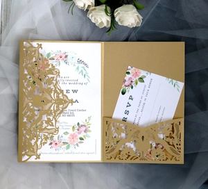 Close-up of laser-cut gold lace wedding invitation set with floral liner and RSVP card