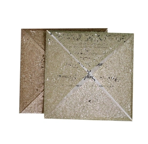 Laser cut glitter wedding invitation cards in gold and champagne with hollow floral design