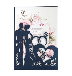 Detail of laser-cut navy wedding invitation with Mr & Mrs silhouette and floral insert