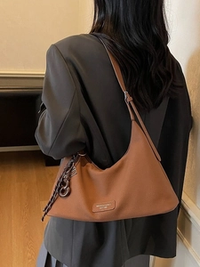 Vintage brown leather hobo bag for women with adjustable strap and side knot detail