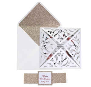 Detailed laser cut lace wedding invitation set with champagne gold glitter lining and ribbon