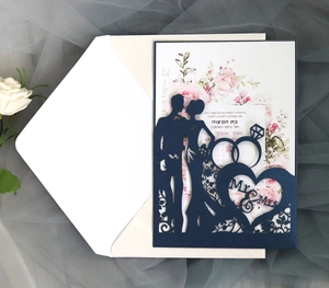Detail of laser-cut navy blue wedding invitation with Mr & Mrs silhouette and floral insert