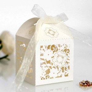 Elegant laser-cut floral wedding favor gift box in white with a delicate organza ribbon bow