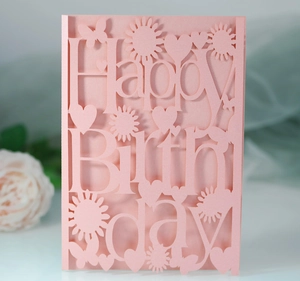 Close-up of pink laser-cut Happy Birthday card with sunflower and heart patterns